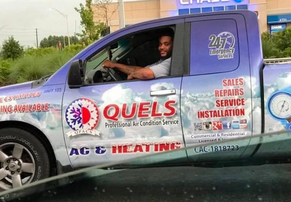 Quel Moragne at the wheel of a wrapped Quel's Professional AC service truck.